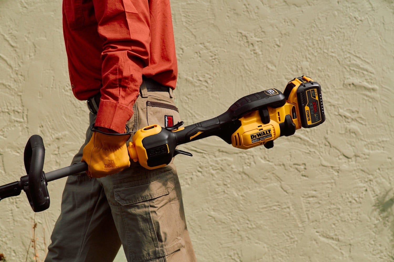 A man using a DeWalt trimmer A man using a DeWalt trimmer